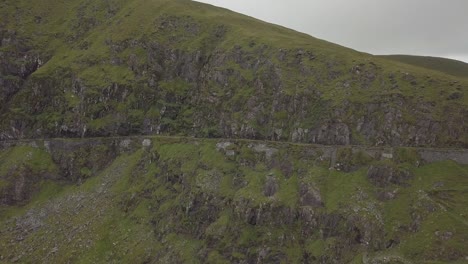 Aerial-footage-of-a-car-driving-on-mountain-roads