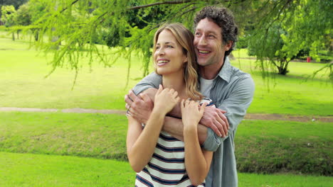 Smiling-couple-embracing-in-park