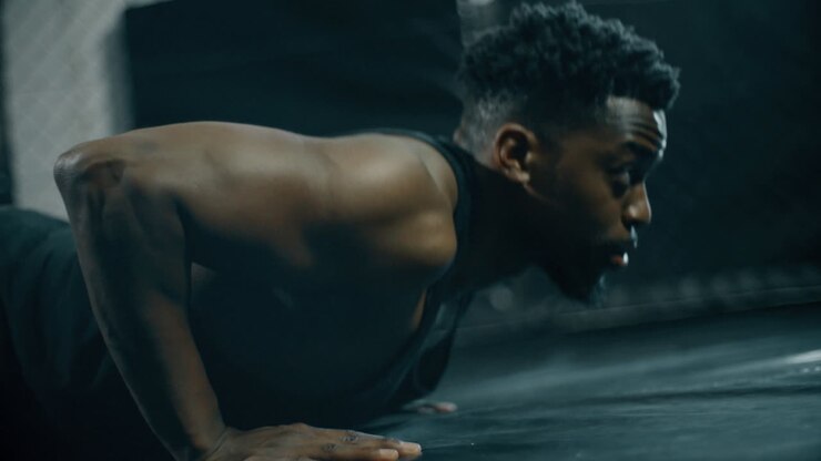 Man Doing Press Ups in Gym