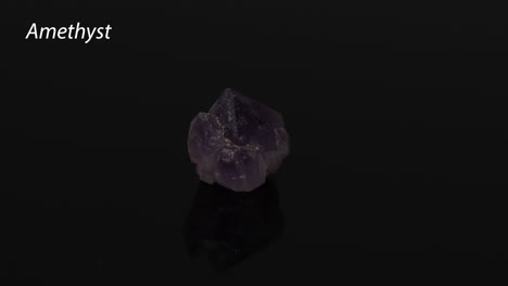 rotating amethyst crystal on a reflective surface