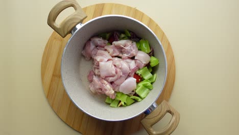 preparing chicken and vegetables in a pot