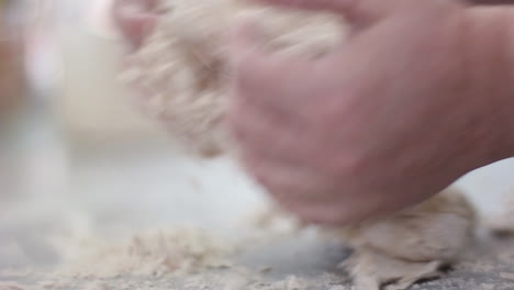 close up on mom's hands as she kneads the dough