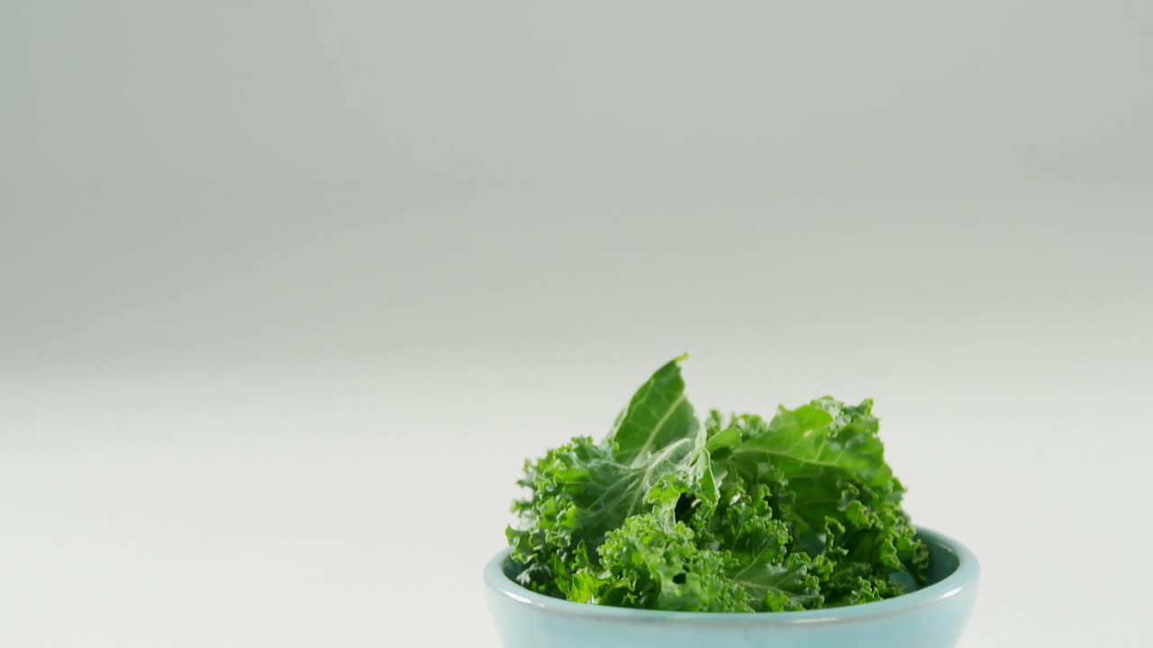 Lettuce in bowl placed on white surface 4K 4k