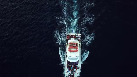 overhead aerial view of a tourist yacht with a group of black people, off the coast of curacao, dutch caribbean island