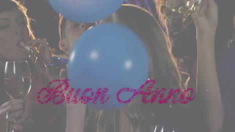 Animation-of-buon-anno-text-in-pink-over-balloons-and-crowd-of-celebrating-people-partying