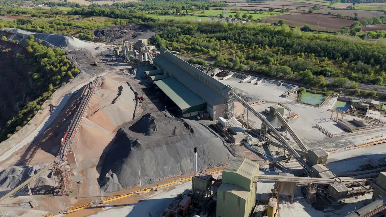 Wide aerial view of aggregates quarry in Coalville United Kingdom with gravel piles and asphalt processing zones