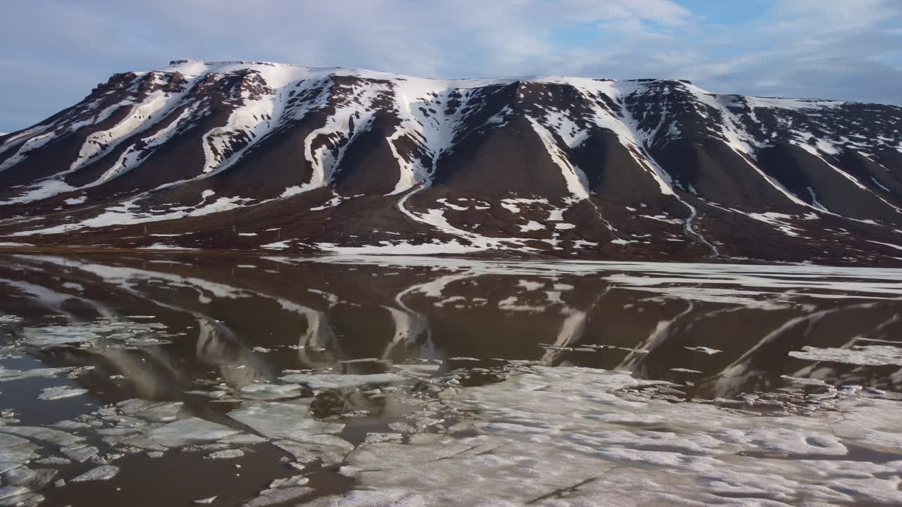Snowy Mountains Reflected in Icy Water
