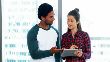 Male-and-female-executives-using-digital-tablet