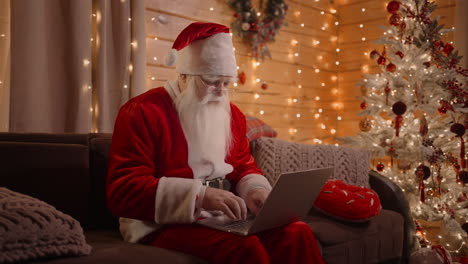 santa responds to emails browses the internet bank and works on a laptop