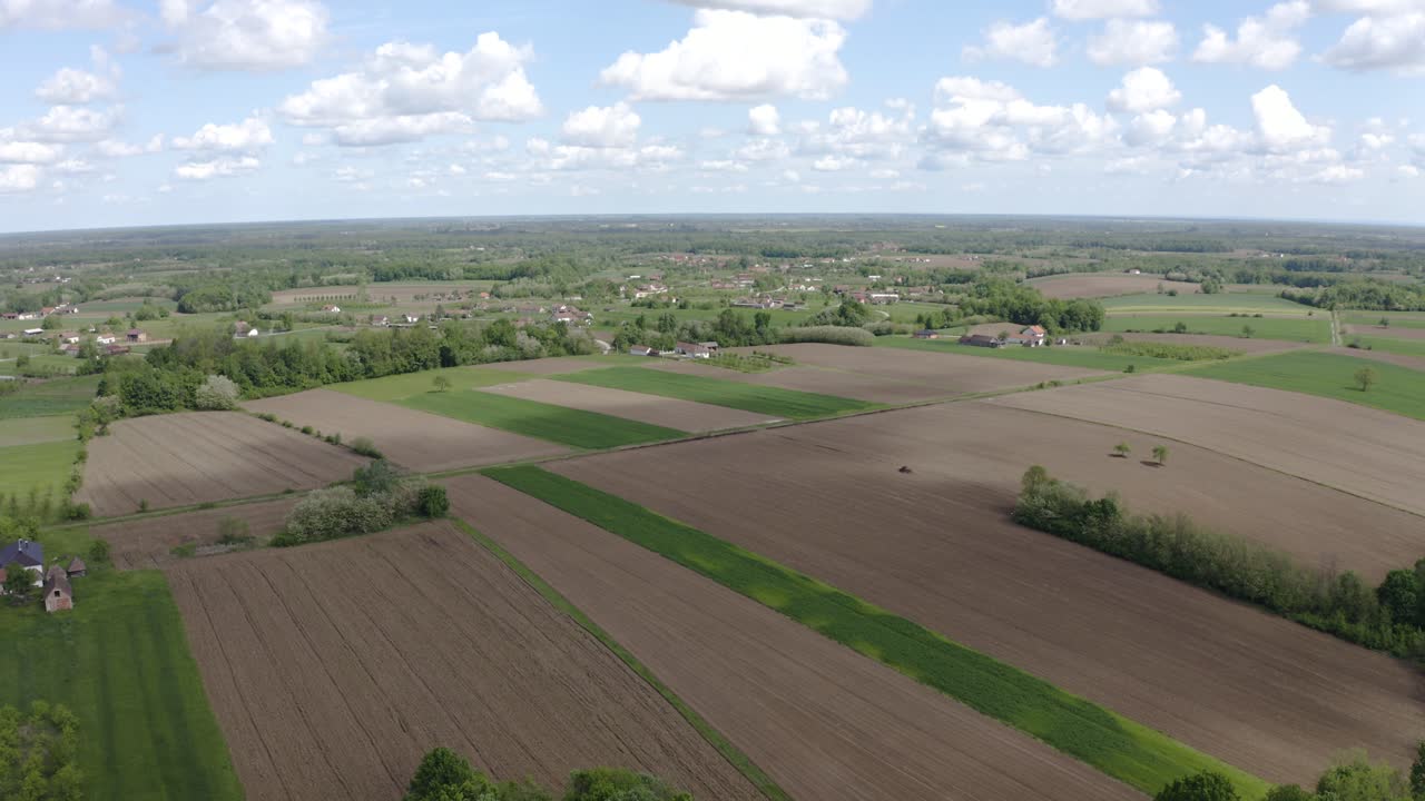 Curving the camera while forwarding the drone and film agricultural field, stunning nature and well organised small village in Bosnia and Herzegovina