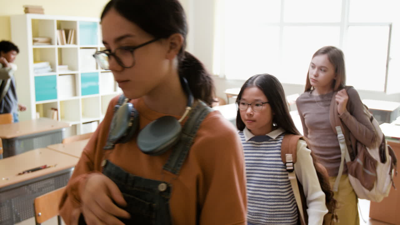 Students walking through a bright classroom