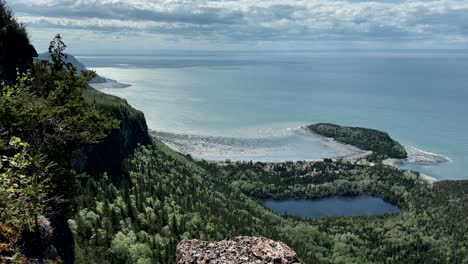 Beautiful-Scenery-At-Bic-National-Park-With-Green-Forest-By-The-Mountains-And-Calm-Blue-Ocean-In-Rimouski,-Quebec,-Canada