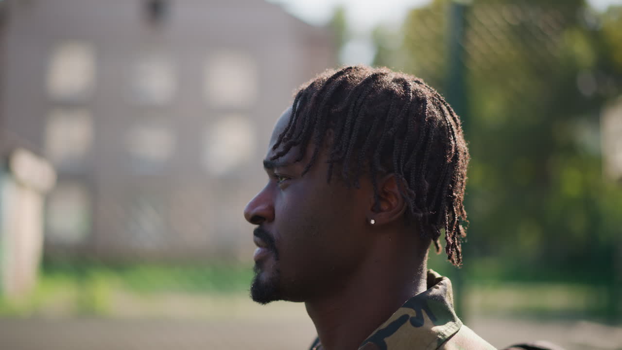 Camouflaged Soldier Portrait, Quiet Soldier With Camouflage And Warm Lighting, Calm Military Personnel With Camouflage Clothing Captured Against Blurred Background With Warm Cinematic Quality