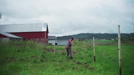 man at work fixing fence at the field