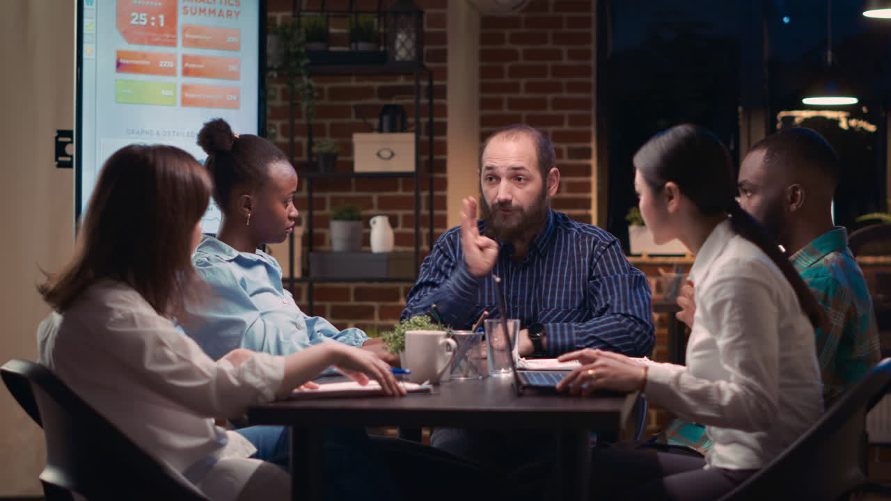 Diverse coworkers brainstorming, team leader explaining strategy plan