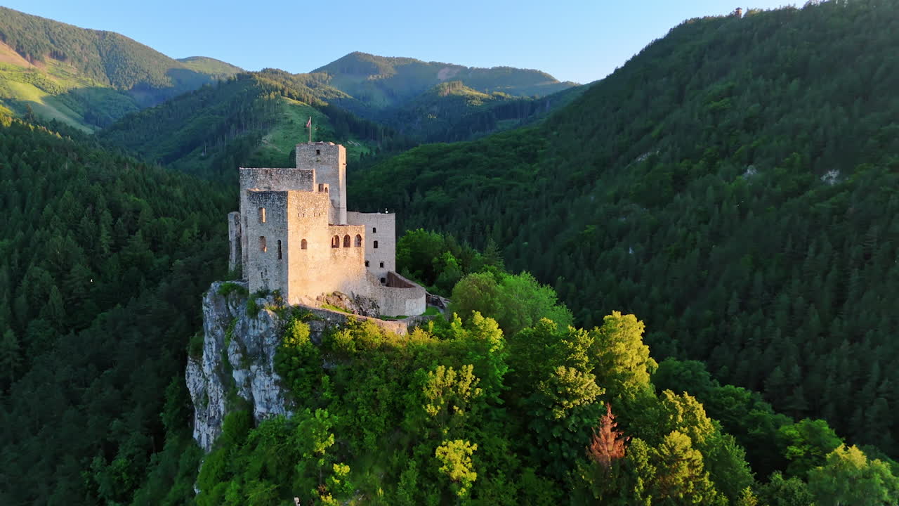 Approaching the old medieval castle located on the mountain top. Stunning verdant mountains around. Slovakia scenery