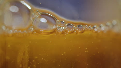 extreme macro close up of abstract, orange, viscous liquid bubbles