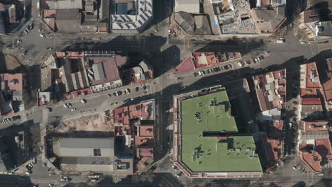 Fly-over-town-development-in-urban-borough.-Top-down-shot-of-streets-and-various-buildings.-Barcelona,-Spain