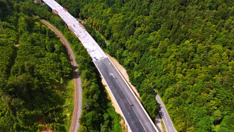 wide freeway being built over the highways. top view on the road construction in the mountainous area