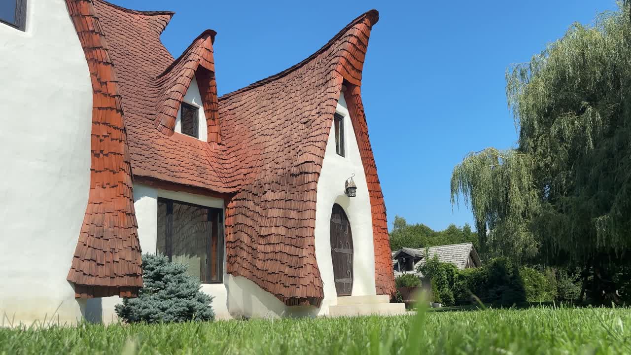Blonde woman walking in Romanian Castelul de Lut. Low angle view