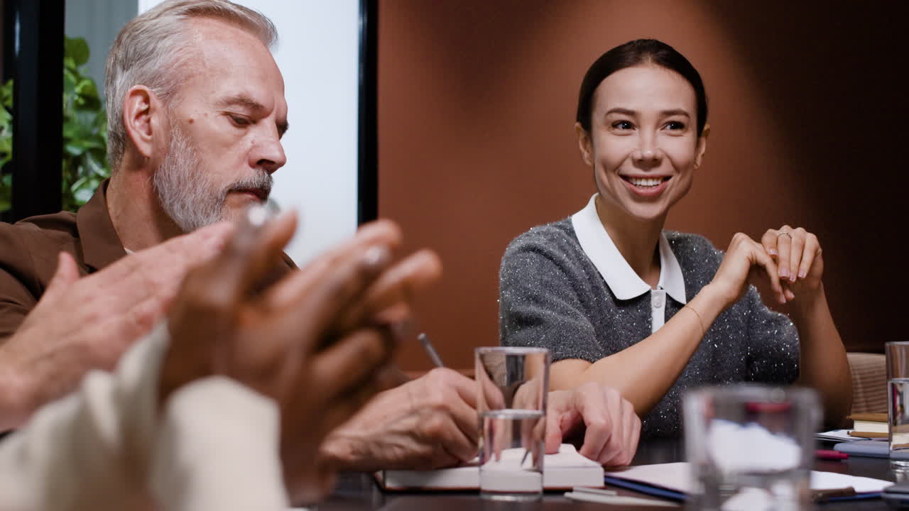 Business colleagues applauding at a corporate meeting