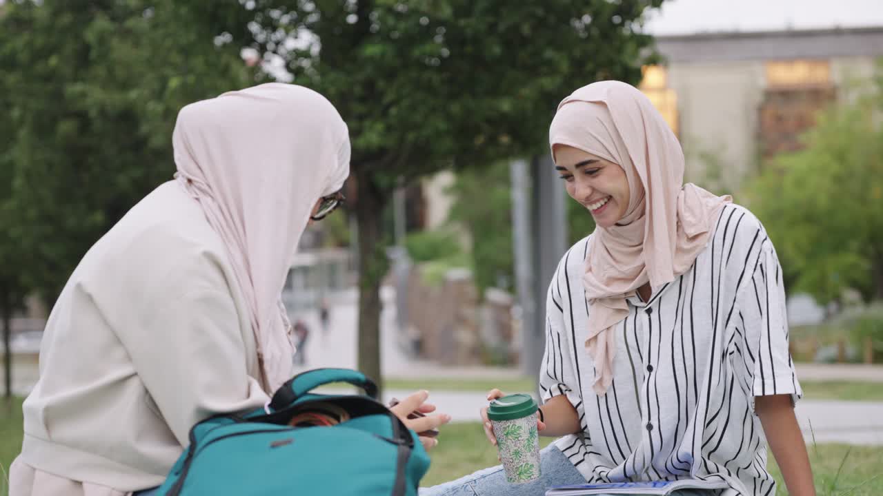 Two Muslim women chatting in a park
