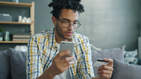 man paying online with credit card on smartphone