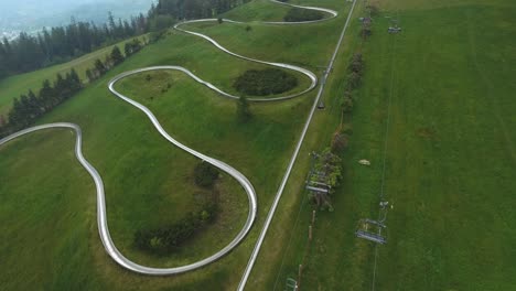 a summer toboggan track and chairlift on top of a mountain in a tourist town in poland during summer