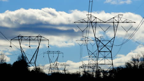 Electrical-towers-and-swaying-transmission-lines-with-clouds-moving-in-time-lapse-motion