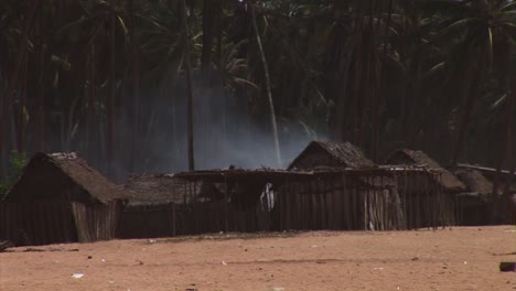 smoke coning from a fishing village on the beach in nigeria