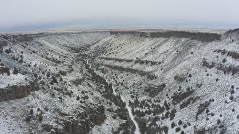 slow tracking drone shot of snowy canyon