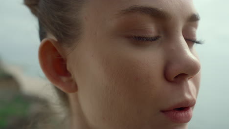 Face-woman-making-breathing-exercise-on-beach-closeup.-Girl-doing-yoga-on-nature