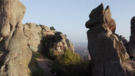 fly-through aerial drone shot going in between the huge natural rock formations of the belogradchik clifffs, located in the province of vidin in bulgaria