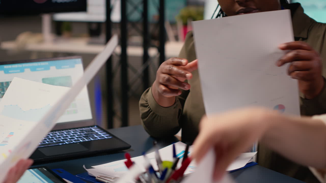 Ambitious career driven multiethnic professionals collaborate over analytics