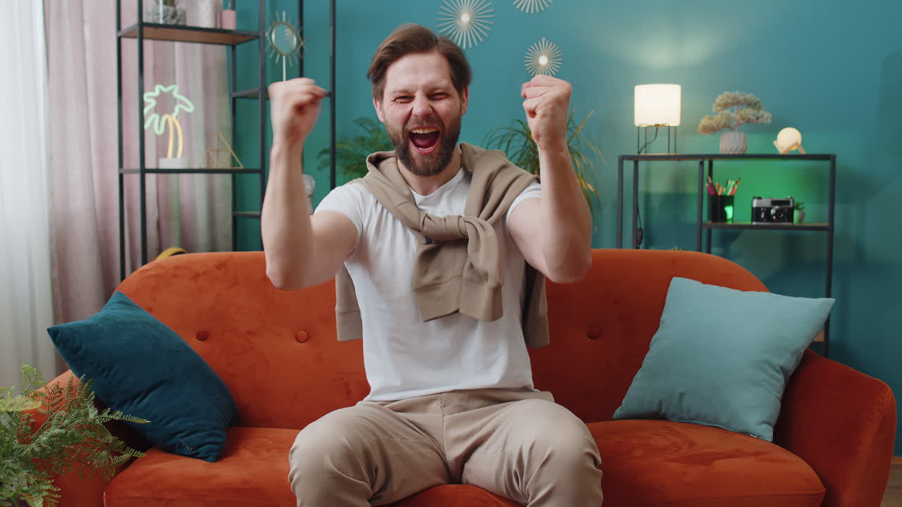 Excited happy young man surprised shocked by sudden victory good win news celebrating wow reaction