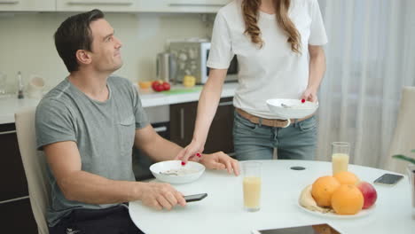 happy couple drinking orange juice during healthy breakfast in living room.