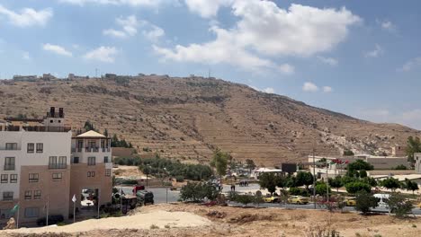 Outside-of-Petra-valley-in-Wadi-Musa,-Jordan-in-the-middle-of-a-rocky-and-mountainous-landscape,-an-UNESCO-heritage-site,-ancient-Nabatean-Kingdom-4K-Establish-Shot