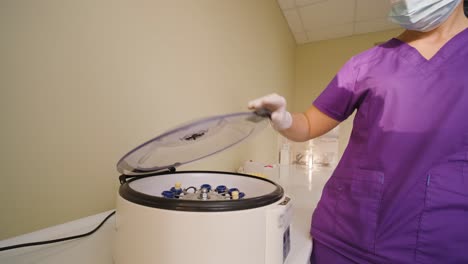 platelet-rich plasma preparation. tube with blood in hands. centrifuge. background