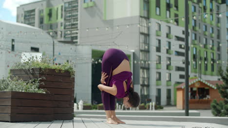 woman practicing yoga outdoors in the city