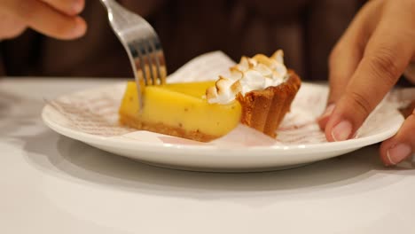 over head view of women eating lemon tart ,