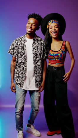stylish couple posing in vibrant studio setting