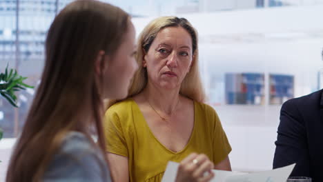 agent informing mother and young adult of best investment strategies