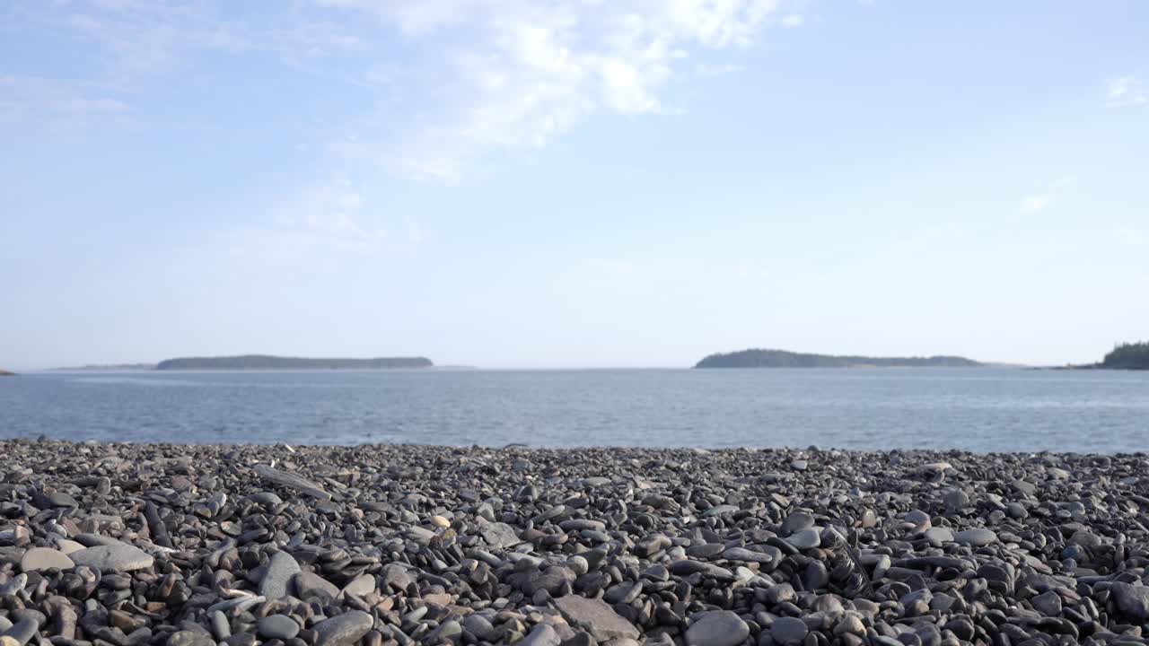 Peaceful and Serene Coastal Scene with a Stone Beach and Calm Blue Sea