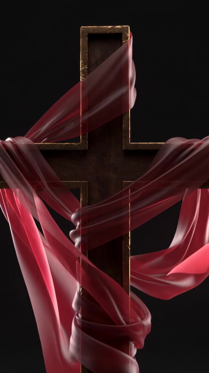 Video verticale: Brezza che solleva un nastro rosso che avvolge una croce di legno in uno studio buio, con luci su finiture dorate.