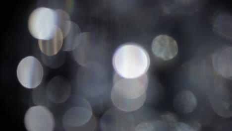 abstract glow bokeh bubble particles flying on black background