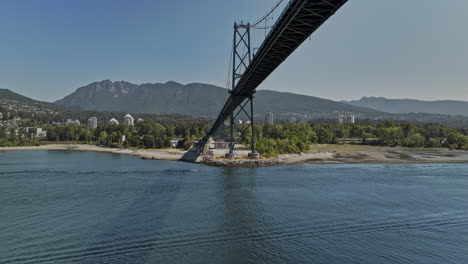 Vancouver-BC-Canada-Aerial-v99-drone-flyover-the-harbour-under-Lions-Gate-Bridge-towards-North-shore-capturing-Wastewater-Treatment-Plant-and-mountain-views---Shot-with-Mavic-3-Pro-Cine---July-2023