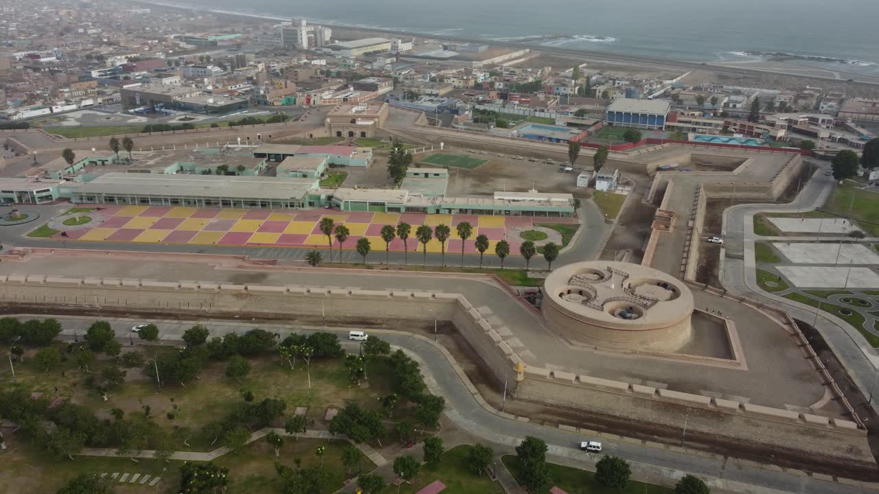 Aerial shot of 18th century spanish military fortress called "Fortaleza Real Felipe" built near coast of pacific ocean. Drone slowly orbits around. Located in Callao, Peru