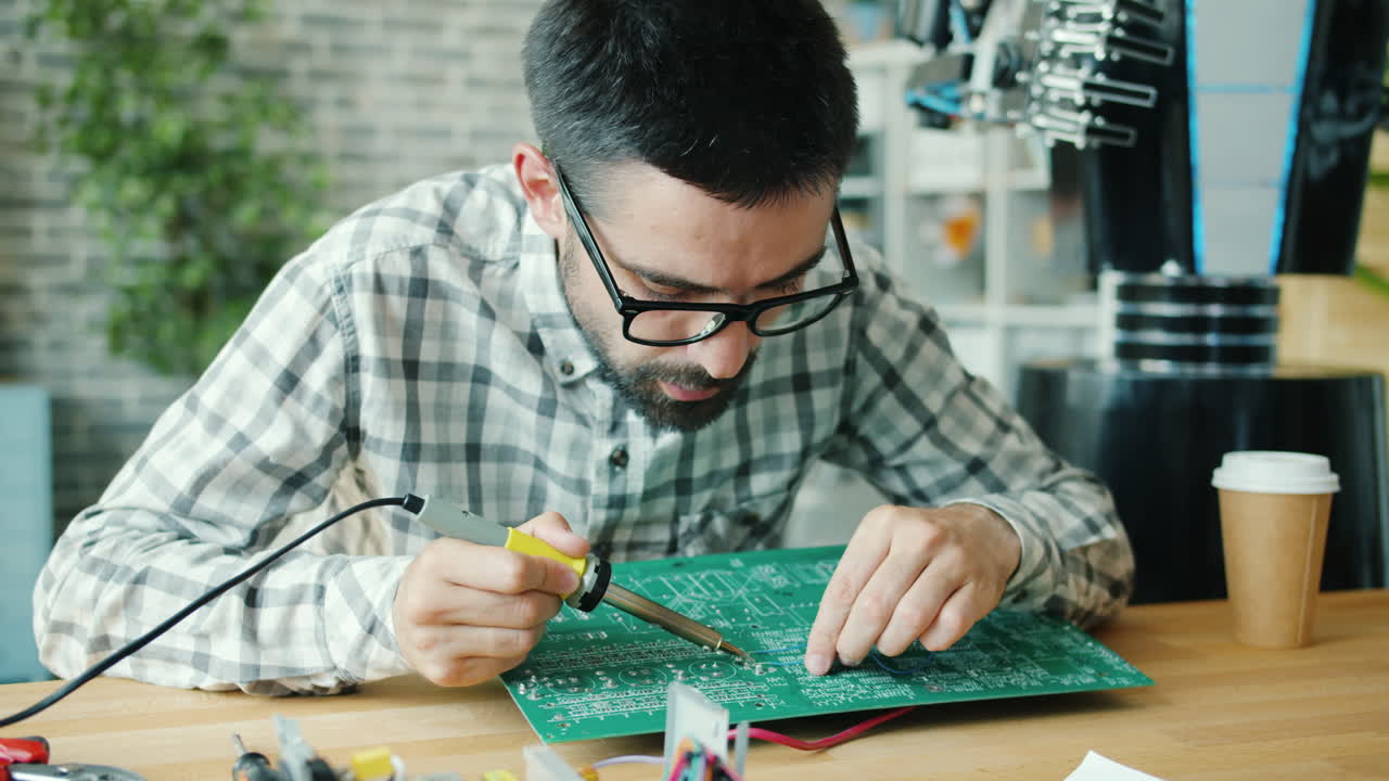Technician repairing a circuit board