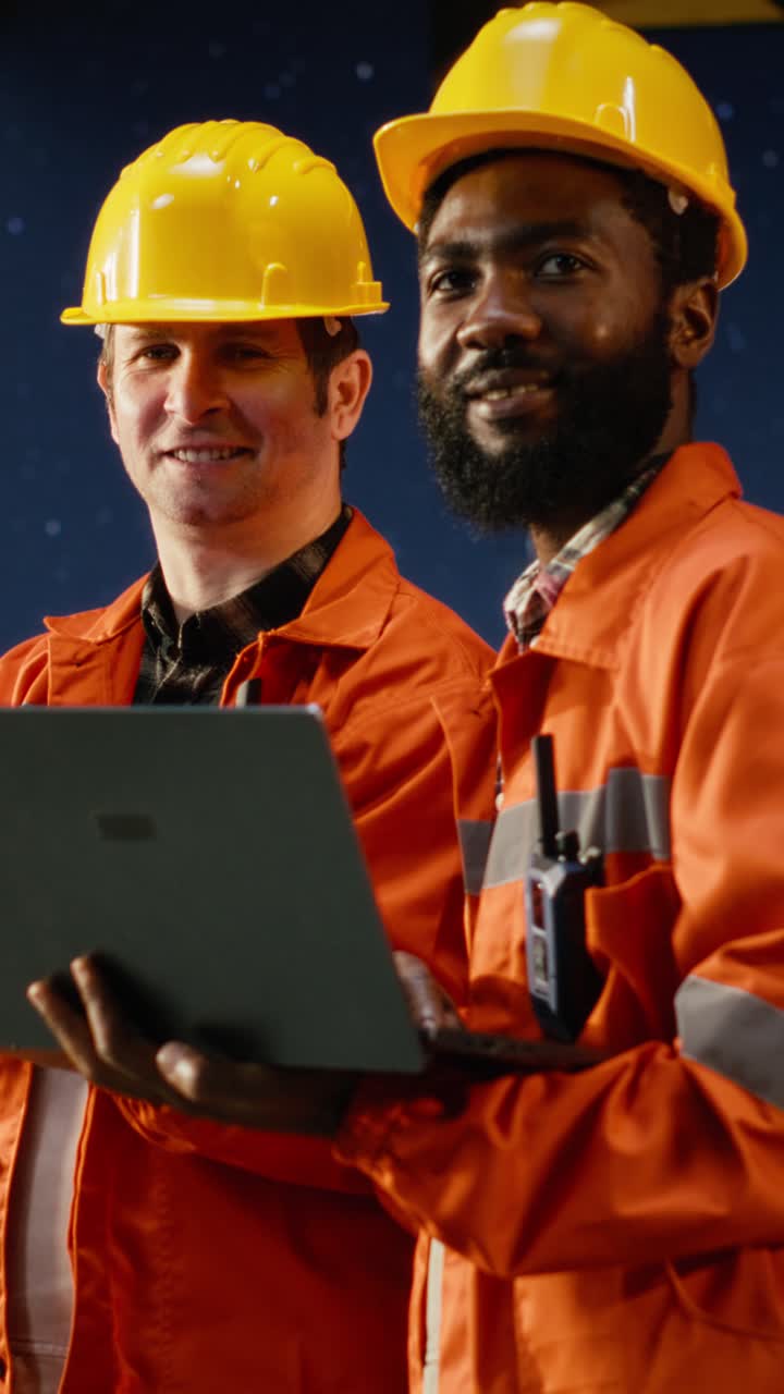 Vertical Video Portrait of engineers work on offshore oil rig platform late at night