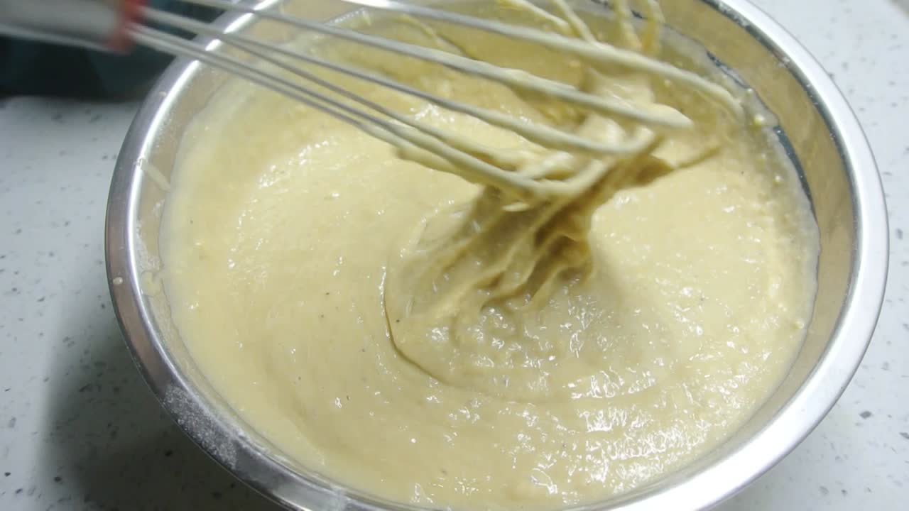 Mix the flour and other ingredients until well blended manually. It is the early stage of the baking bread and cakes process. This will take some time to get a good mix.